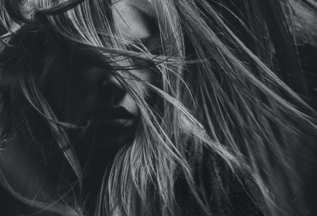 woman with hair covering her eyes